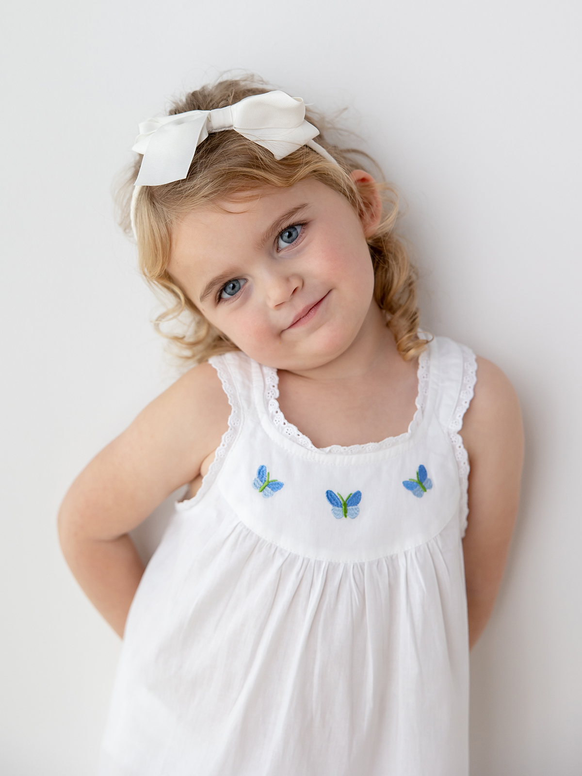 a little girl wearing the zoe dress